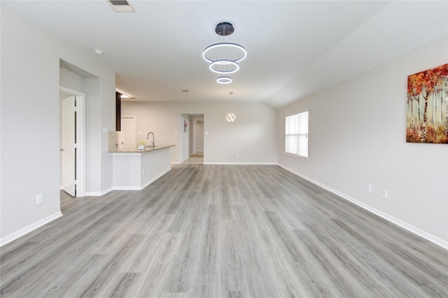 9207 Ranch Ridge Ln, Richmond, TX 77407 - unfurnished living room with light wood-style floors and vaulted ceiling