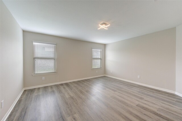 9207 Ranch Ridge Ln, Richmond, TX 77407 - empty room featuring wood finished floors and baseboards