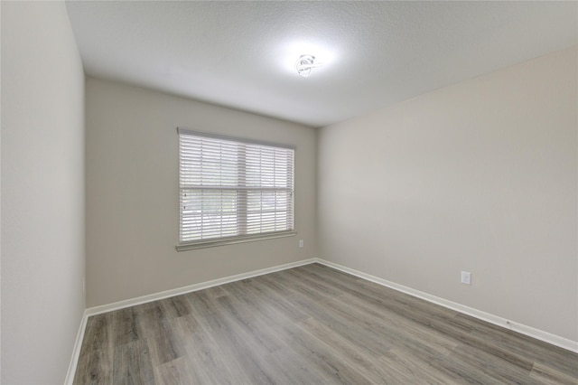 9207 Ranch Ridge Ln, Richmond, TX 77407 - empty room featuring wood finished floors and baseboards