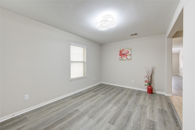 9207 Ranch Ridge Ln, Richmond, TX 77407 - spare room featuring light wood-type flooring and a textured ceiling