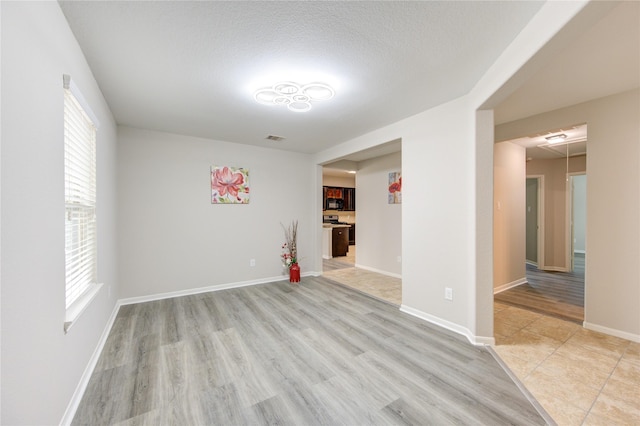 9207 Ranch Ridge Ln, Richmond, TX 77407 - empty room featuring light wood-type flooring and baseboards
