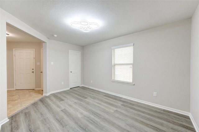 9207 Ranch Ridge Ln, Richmond, TX 77407 - spare room featuring light wood finished floors and baseboards