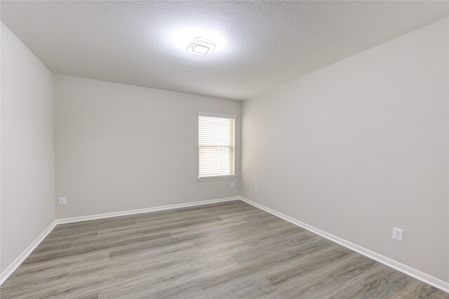 9207 Ranch Ridge Ln, Richmond, TX 77407 - unfurnished room featuring light wood-style flooring and a textured ceiling