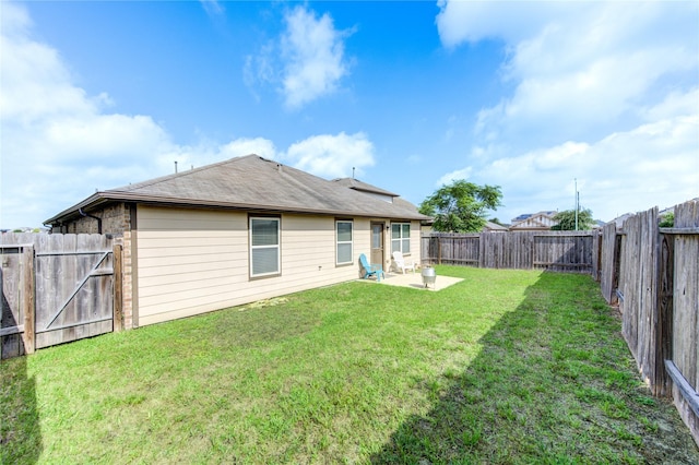 9207 Ranch Ridge Ln, Richmond, TX 77407 - back of property featuring a fenced backyard, a patio area, and a gate