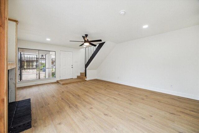 7822 Pacific Pearl St, Houston, TX 77072 - unfurnished living room with stairs, a ceiling fan, wood finished floors, and recessed lighting