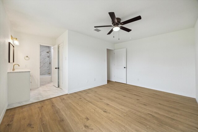 7822 Pacific Pearl St, Houston, TX 77072 - unfurnished bedroom with light wood finished floors, connected bathroom, and ceiling fan
