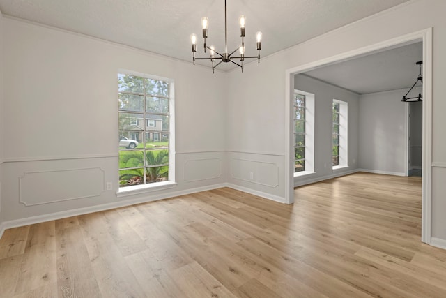 6515 Pebble Beach Dr, Houston, TX 77069 - unfurnished dining area with a chandelier, plenty of natural light, wood finished floors, ornamental molding, and a decorative wall