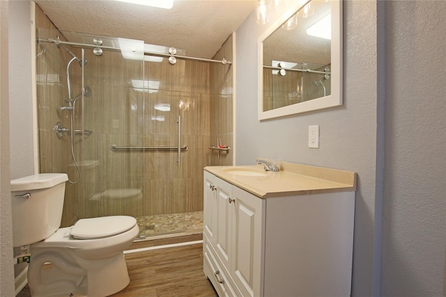 1305 Fairview Dr, Alvin, TX 77511 - bathroom with tiled shower, wood finished floors, a textured ceiling, and vanity
