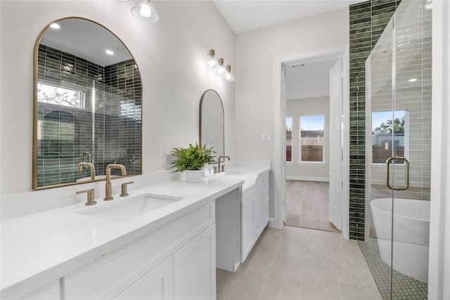 8646 Alcott Dr, Houston, TX 77080 - bathroom with double vanity, plenty of natural light, a shower stall, and a freestanding tub