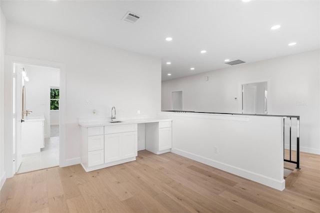8646 Alcott Dr, Houston, TX 77080 - kitchen with light wood-style floors, recessed lighting, white cabinetry, and light countertops