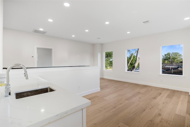 8646 Alcott Dr, Houston, TX 77080 - kitchen with light wood-style floors, recessed lighting, light stone counters, and open floor plan