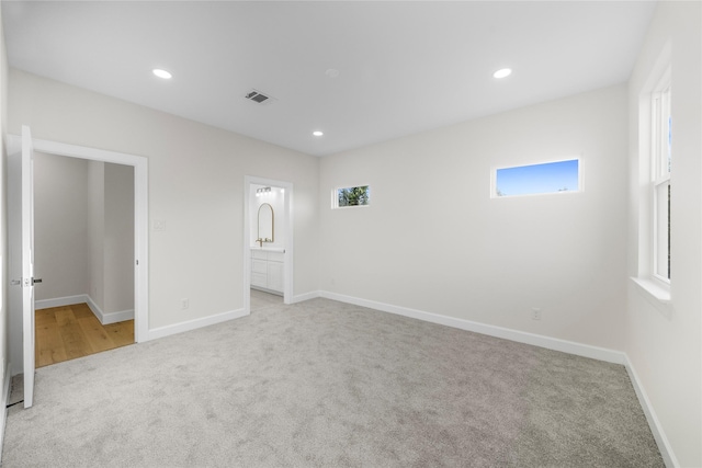 8646 Alcott Dr, Houston, TX 77080 - unfurnished bedroom featuring carpet, multiple windows, recessed lighting, and connected bathroom