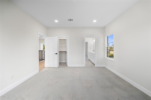 8646 Alcott Dr, Houston, TX 77080 - unfurnished bedroom with light colored carpet, recessed lighting, a spacious closet, connected bathroom, and a closet
