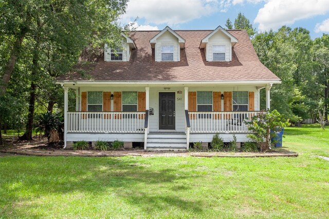 541 N Village Creek Pkwy, Lumberton, TX 77657 - new england style home featuring covered porch, a front yard, and a shingled roof