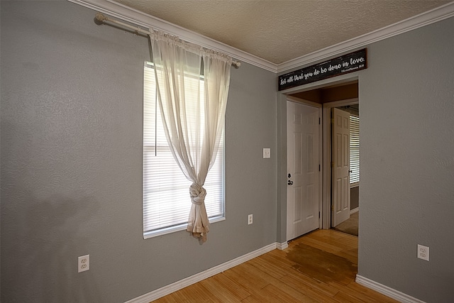 541 N Village Creek Pkwy, Lumberton, TX 77657 - unfurnished room featuring wood finished floors, ornamental molding, and a textured ceiling