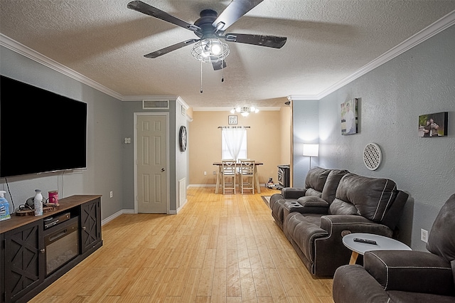 541 N Village Creek Pkwy, Lumberton, TX 77657 - living area with a textured ceiling, ceiling fan, light wood finished floors, and crown molding