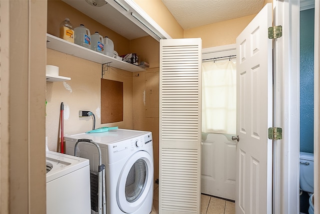 541 N Village Creek Pkwy, Lumberton, TX 77657 - laundry area featuring light tile patterned floors and washer and clothes dryer