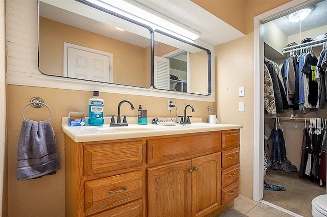 541 N Village Creek Pkwy, Lumberton, TX 77657 - full bath with double vanity, a spacious closet, and tile patterned flooring