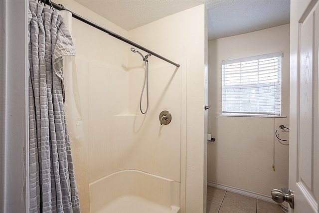 541 N Village Creek Pkwy, Lumberton, TX 77657 - bathroom featuring curtained shower, tile patterned floors, and a textured ceiling