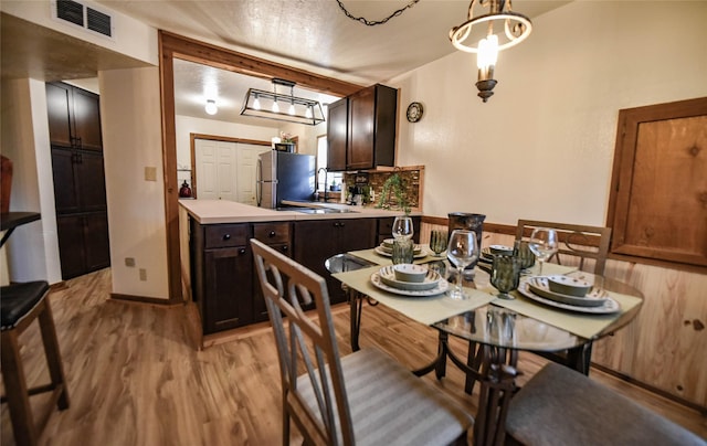 507 W Fawn St, Caldwell, TX 77836 - dining room with light wood-type flooring and a chandelier
