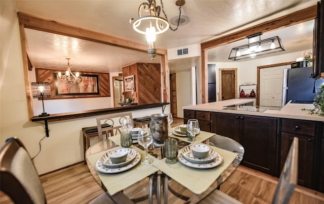 507 W Fawn St, Caldwell, TX 77836 - dining room featuring a chandelier and light wood-type flooring
