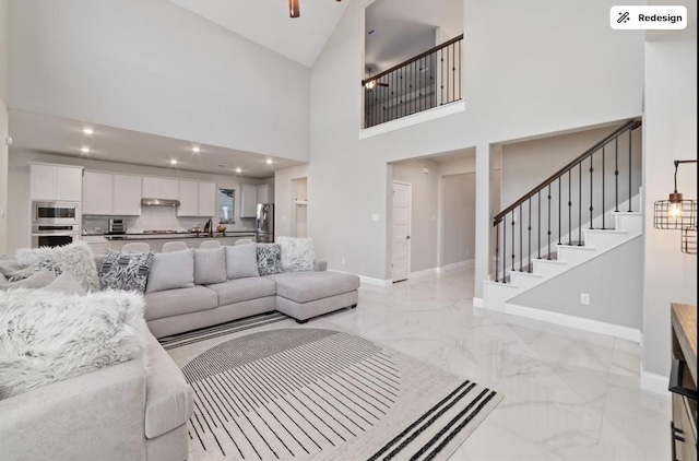 8922 Granary Gate Ln, Richmond, TX 77407 - living area with light marble finish flooring, stairway, high vaulted ceiling, ceiling fan, and recessed lighting