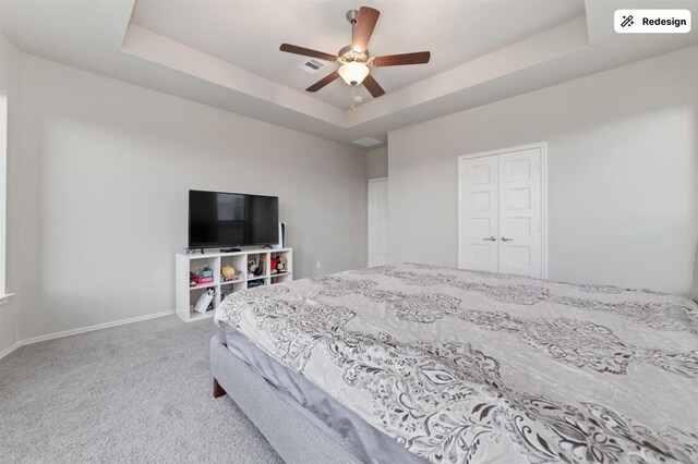 8922 Granary Gate Ln, Richmond, TX 77407 - carpeted bedroom with a raised ceiling, a ceiling fan, and a closet