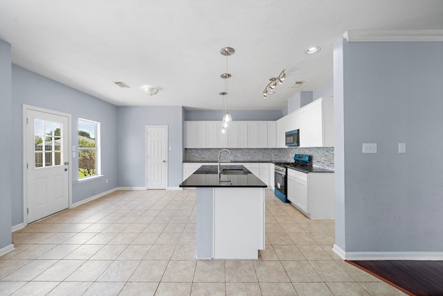 6306 Channelbrook Ln, Spring, TX 77379 - kitchen with gas stove, dark countertops, black microwave, decorative backsplash, and white cabinets