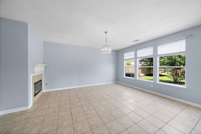 6306 Channelbrook Ln, Spring, TX 77379 - unfurnished living room with a chandelier, a tiled fireplace, and light tile patterned floors