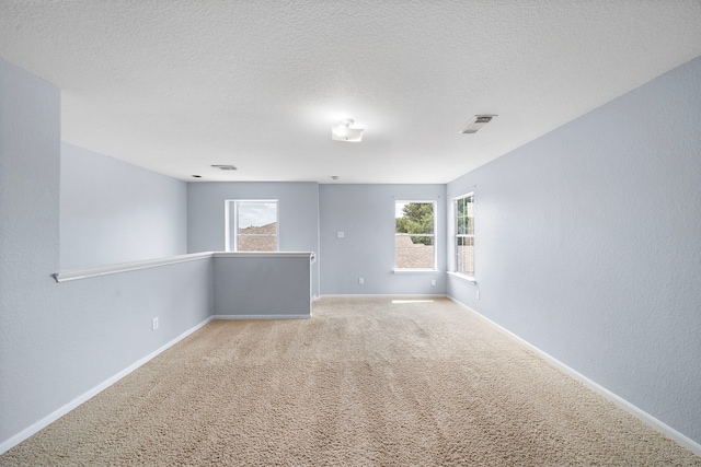 6306 Channelbrook Ln, Spring, TX 77379 - spare room featuring light colored carpet and a textured ceiling