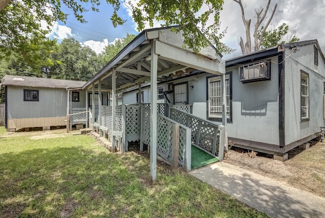1028 N Victory Dr, Houston, TX 77088 - rear view of property with a yard and a wall mounted AC