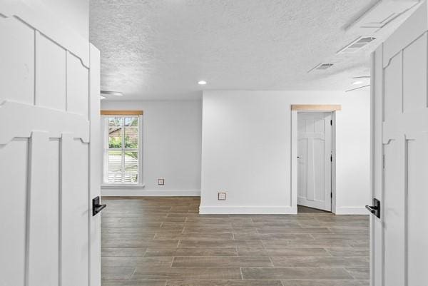 14419 Crosshaven Dr, Houston, TX 77015 - unfurnished room with a textured ceiling, wood finished floors, and recessed lighting
