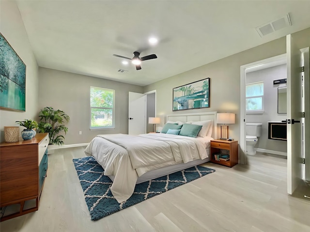 5039 Briscoe St, Houston, TX 77033 - bedroom with wood finished floors, multiple windows, ceiling fan, and ensuite bath