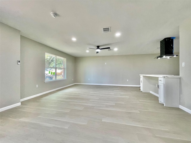 5039 Briscoe St, Houston, TX 77033 - unfurnished living room featuring a ceiling fan, recessed lighting, and light wood finished floors