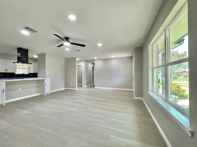 5039 Briscoe St, Houston, TX 77033 - unfurnished living room with ceiling fan, light wood-style flooring, and recessed lighting