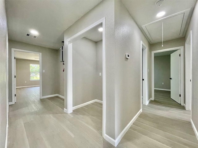 5039 Briscoe St, Houston, TX 77033 - corridor featuring attic access and light wood-type flooring