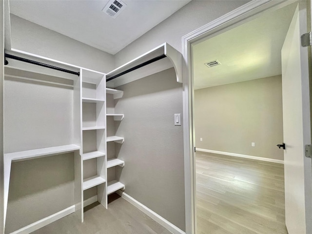 5039 Briscoe St, Houston, TX 77033 - spacious closet with wood finished floors and arched walkways