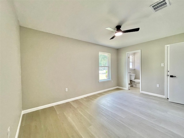 5039 Briscoe St, Houston, TX 77033 - unfurnished bedroom featuring light wood-style floors, connected bathroom, and ceiling fan