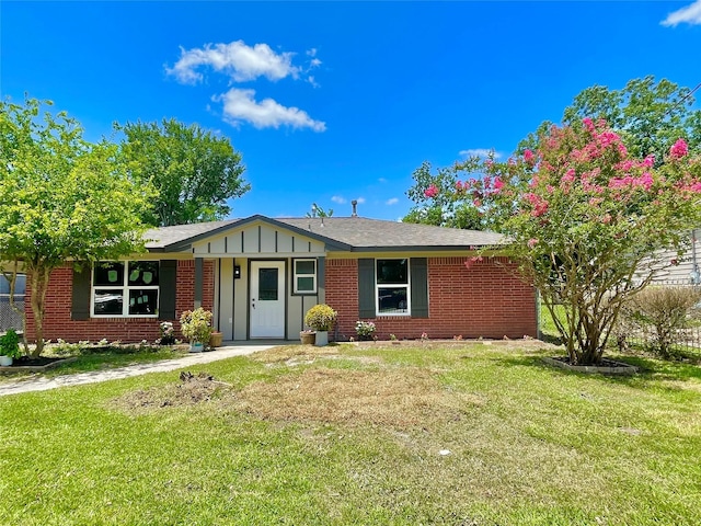 5039 Briscoe St, Houston, TX 77033 - ranch-style home with brick siding, a front yard, and board and batten siding