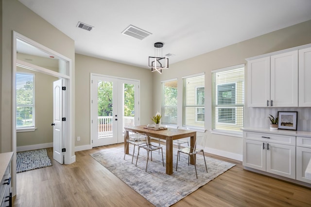 4101 E Rogers St, Houston, TX 77022 - dining room with a chandelier, light wood-type flooring, and french doors