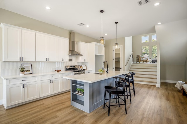 4101 E Rogers St, Houston, TX 77022 - kitchen featuring wall chimney range hood, stainless steel range oven, open shelves, white cabinets, and recessed lighting