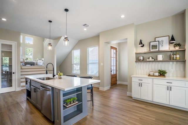 4101 E Rogers St, Houston, TX 77022 - kitchen with open shelves, stainless steel appliances, light countertops, pendant lighting, and white cabinetry