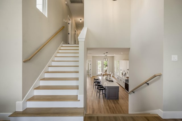 4101 E Rogers St, Houston, TX 77022 - staircase with a high ceiling and wood finished floors