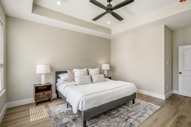 4101 E Rogers St, Houston, TX 77022 - bedroom featuring light wood-style flooring, a tray ceiling, recessed lighting, and a ceiling fan