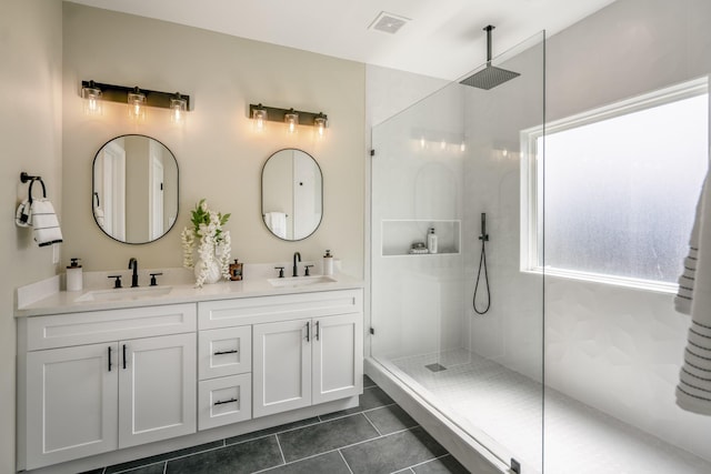 4101 E Rogers St, Houston, TX 77022 - full bath featuring a walk in shower, double vanity, and tile patterned floors