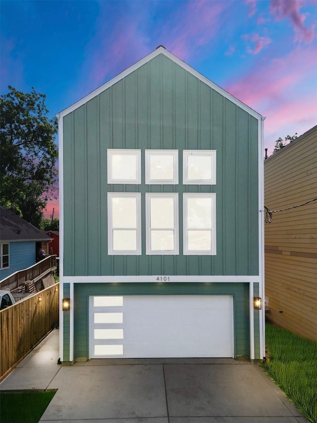 4101 E Rogers St, Houston, TX 77022 - view of front of home with board and batten siding, concrete driveway, and an attached garage