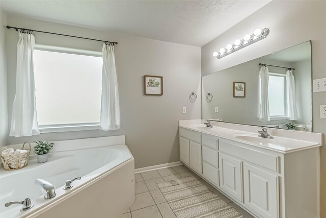 9214 Stingray Ct, Texas City, TX 77591 - bathroom featuring double vanity, a bath, and tile patterned flooring
