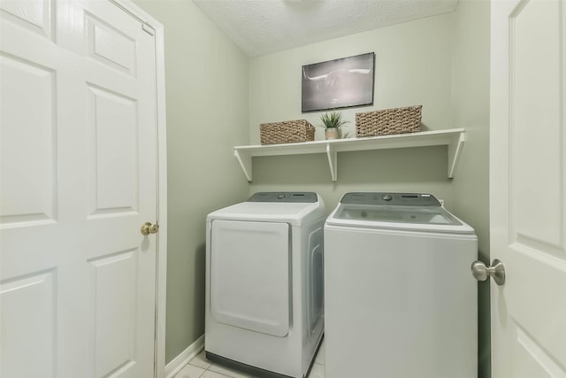 9214 Stingray Ct, Texas City, TX 77591 - laundry room featuring washing machine and clothes dryer, a textured ceiling, and light tile patterned flooring