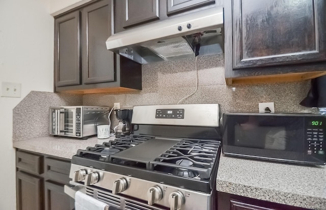 12806 Bauman Rd, North Houston, TX 77037 - kitchen with gas range, under cabinet range hood, black microwave, decorative backsplash, and light countertops