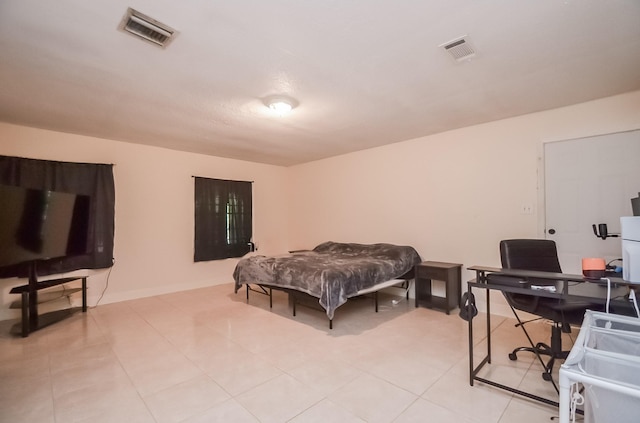 12806 Bauman Rd, North Houston, TX 77037 - bedroom with an office area and light tile patterned floors